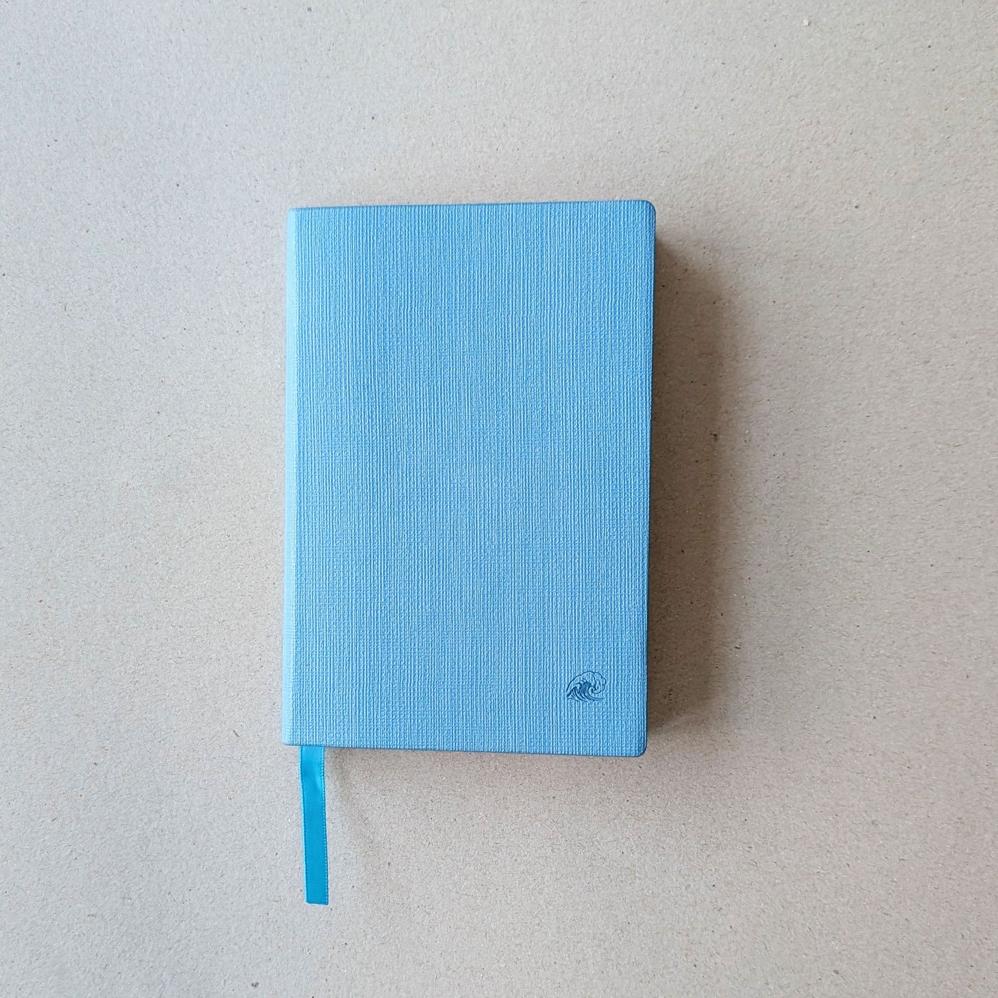Blue notebook on a light gray background
