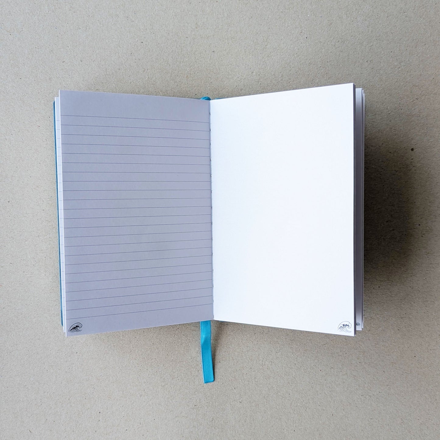 Open notebook with lined pages on a beige background