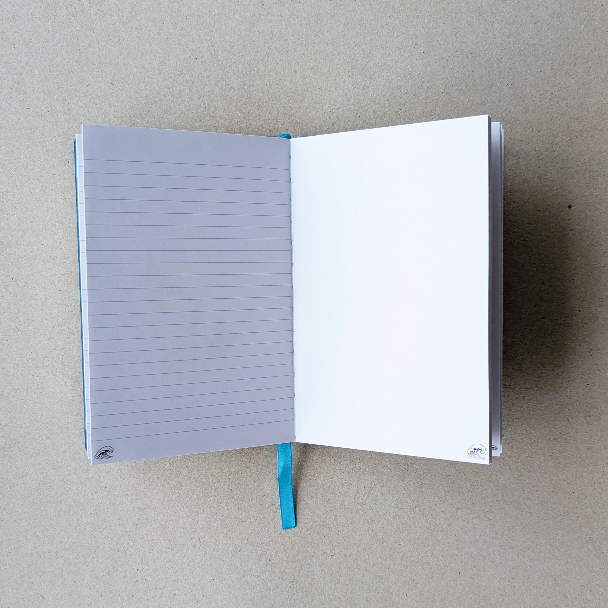 Open notebook with lined pages on a beige background