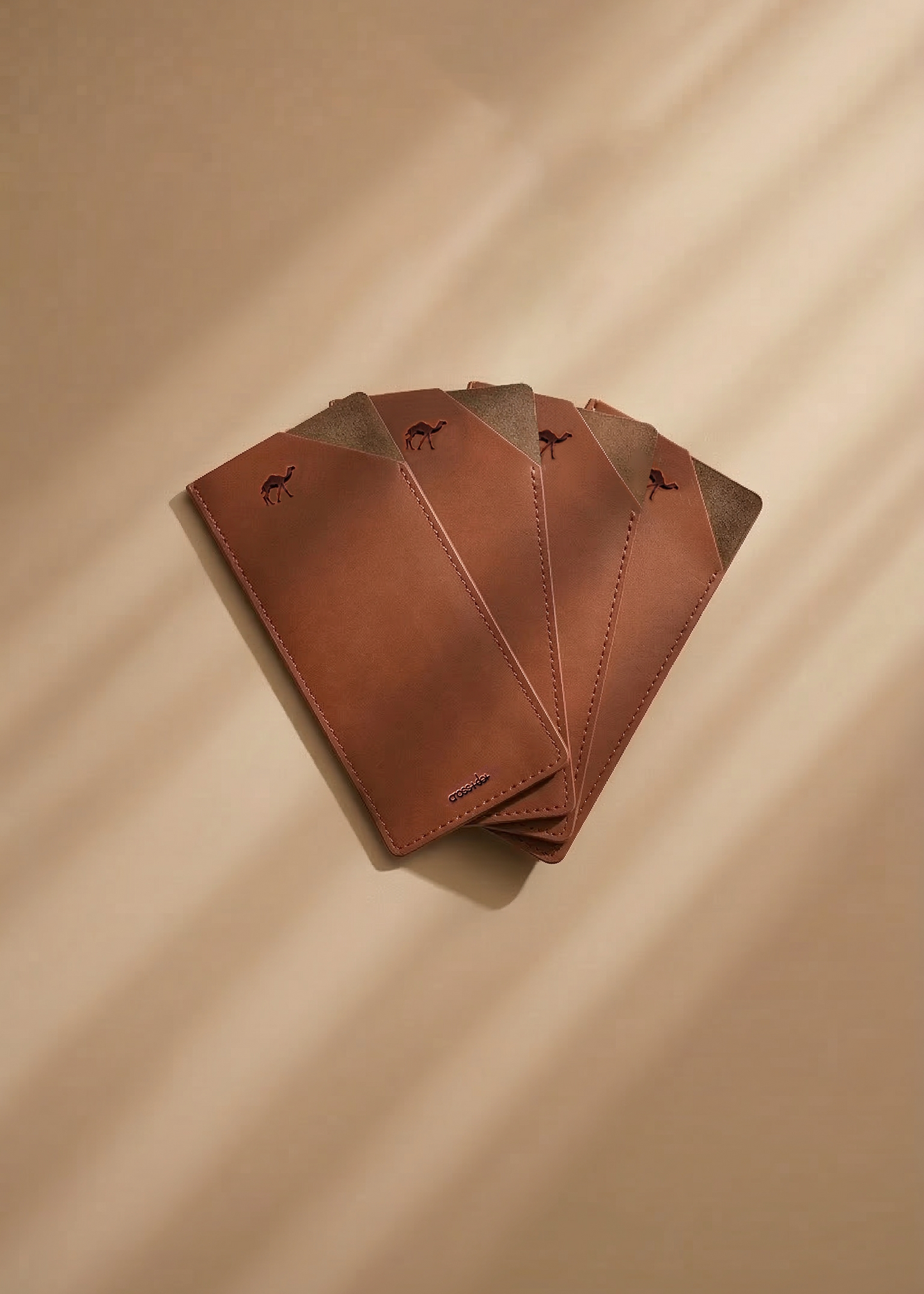 Set of  four brown leather envelopes on a beige background