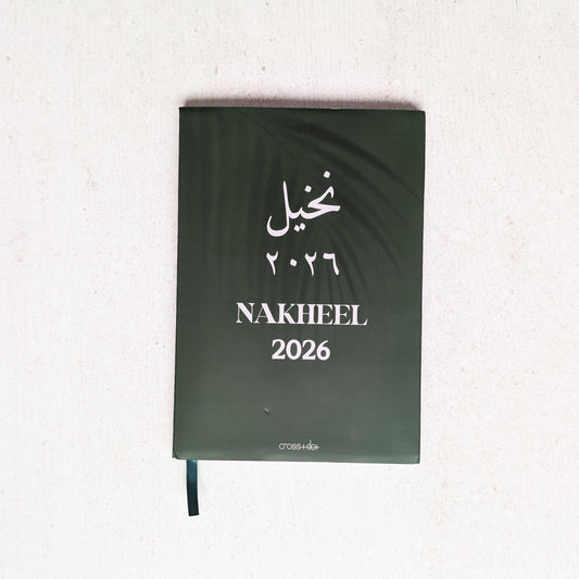 Green notebook with 'Nakheel 2026' text on a white background