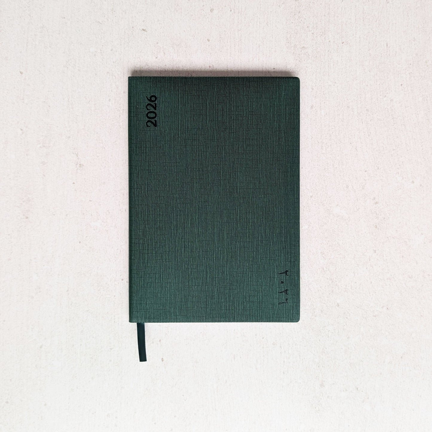 Green notebook on a light gray background