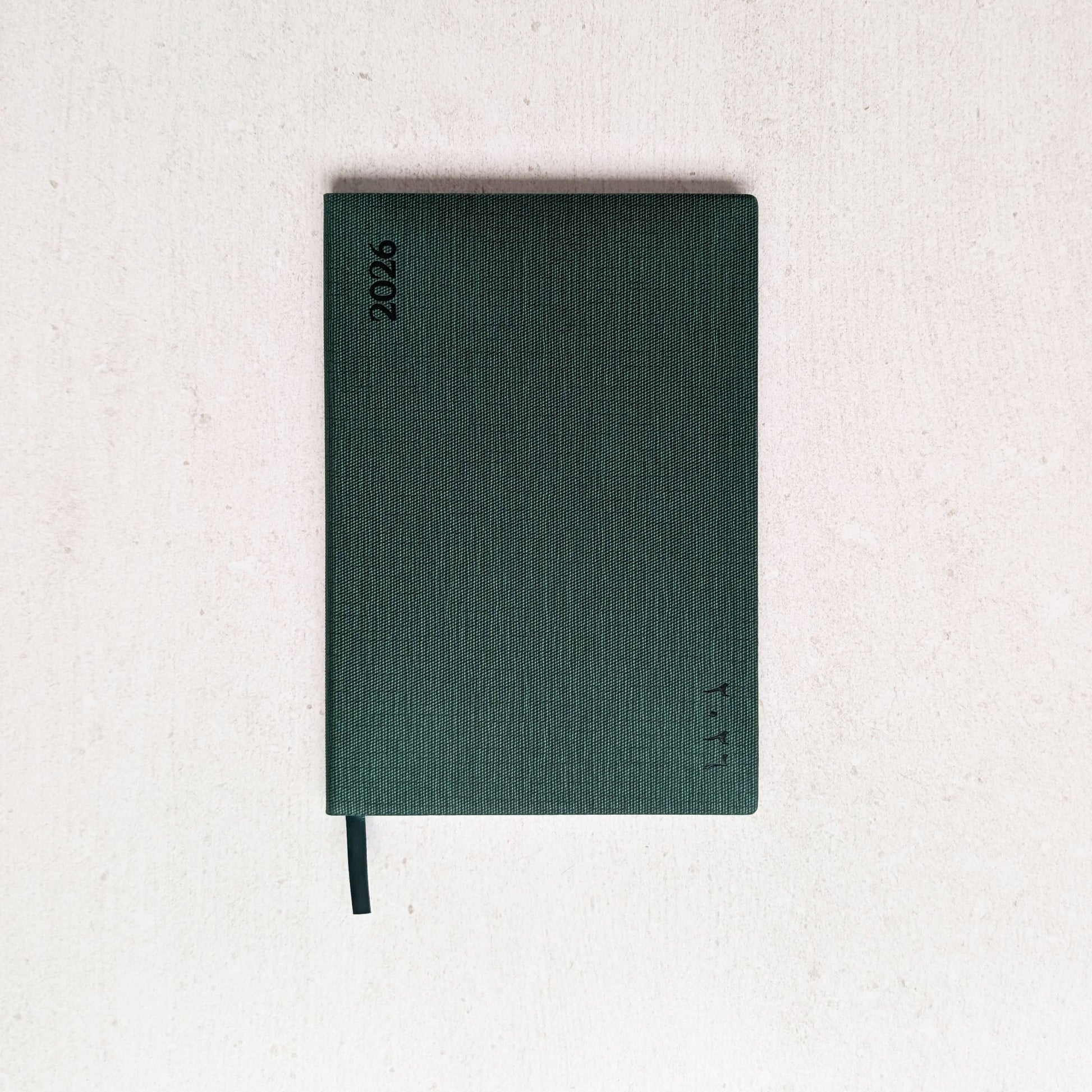 Green notebook on a light gray background