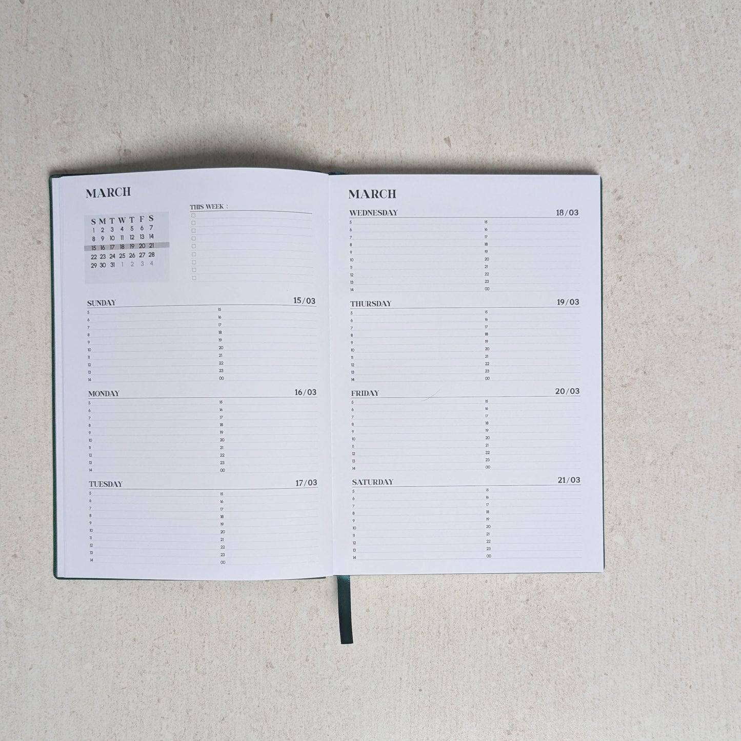 Calendar notebook open to a page with grid layout on a light gray background