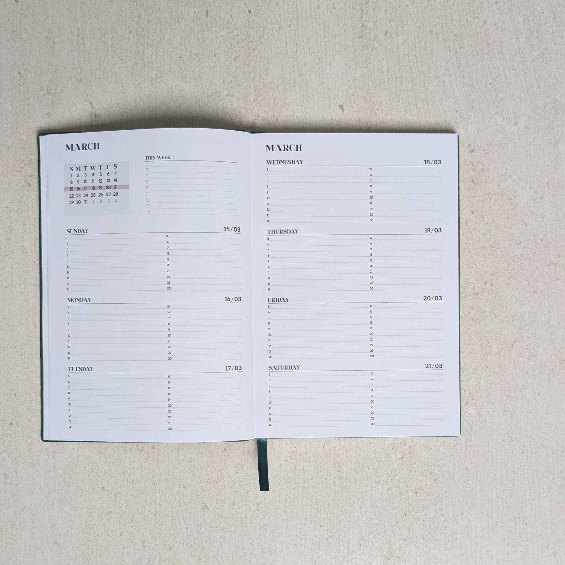 Calendar notebook open to a page with grid layout on a light gray background
